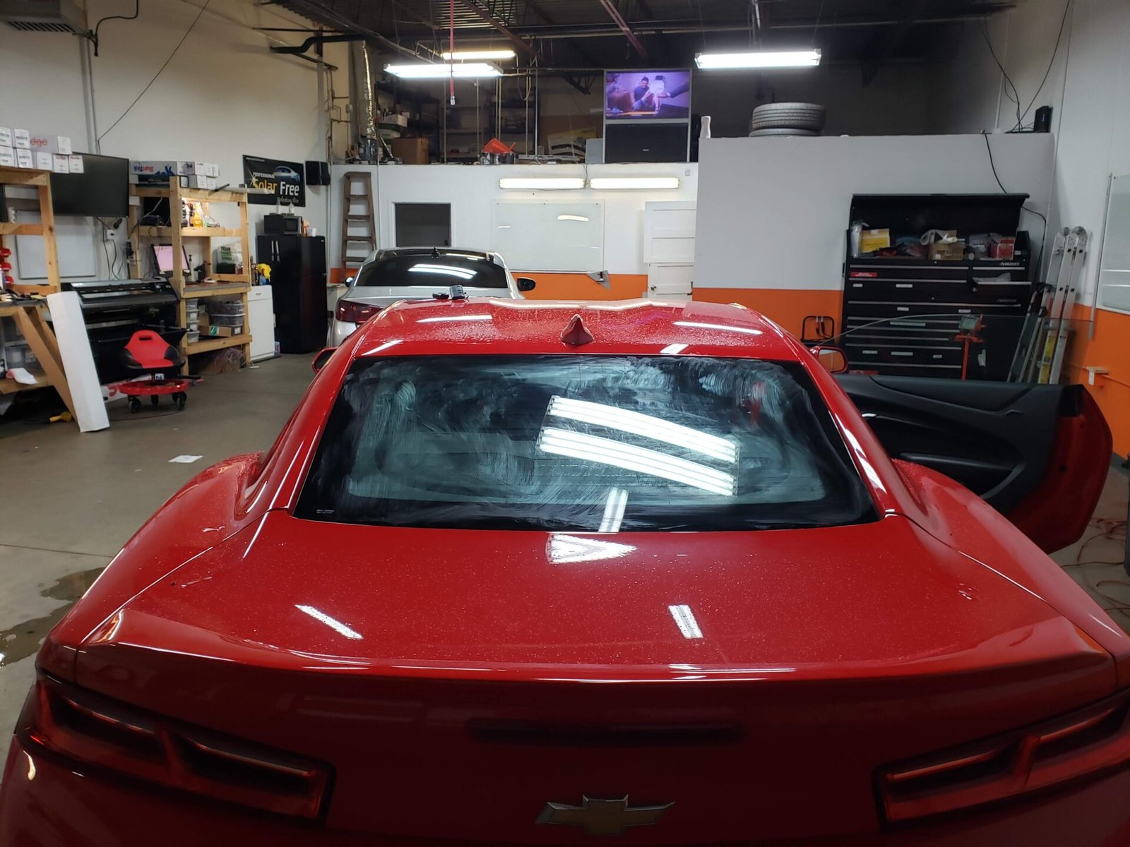 A photo of a red car inside the shop