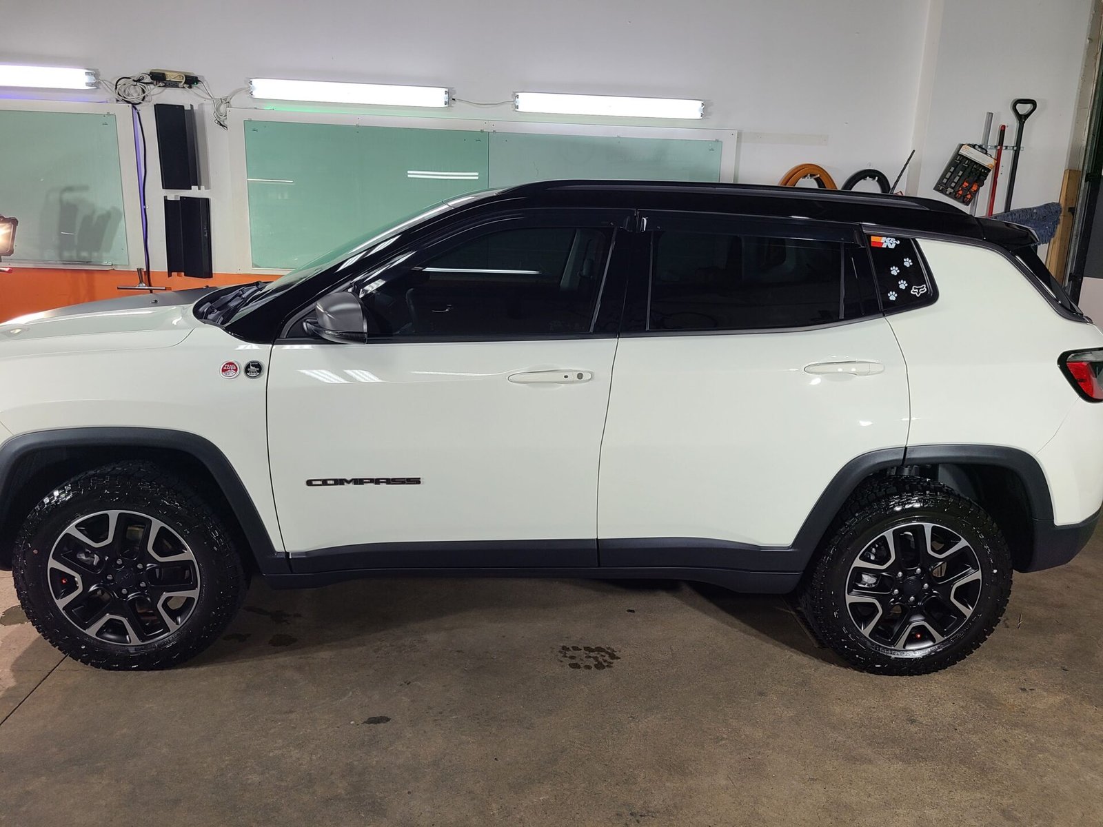 A white suv inside the car shop