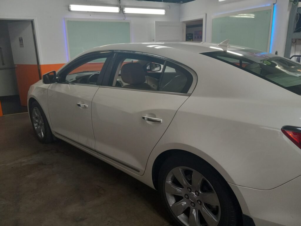A sedan car inside the car shop