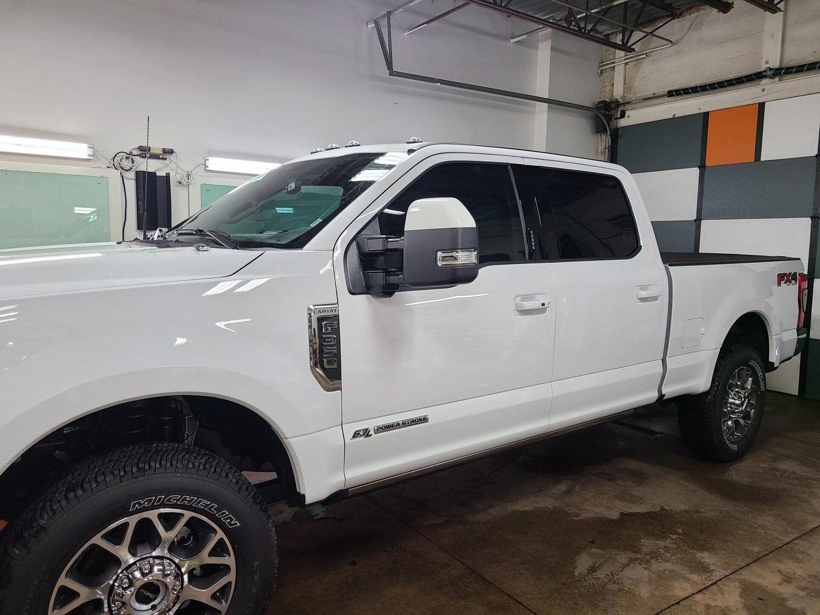 A white pick up car inside the shop