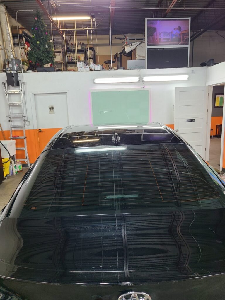 A photo of a black car on a car shop