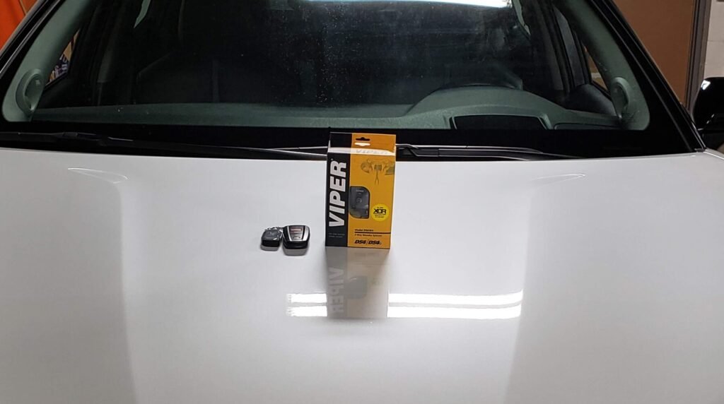 A photo of a remote device on a hood of a car