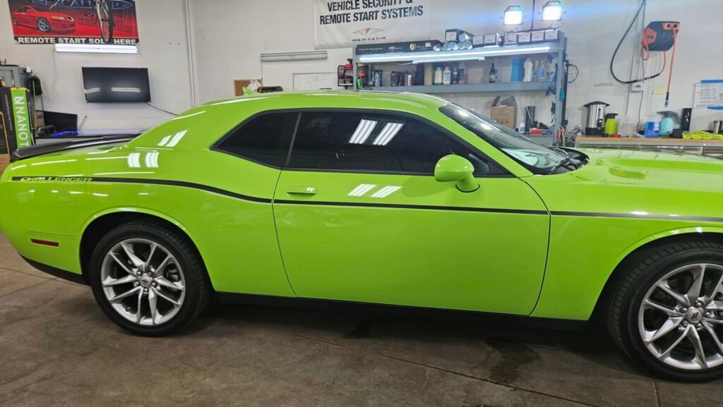 A green car inside the shop