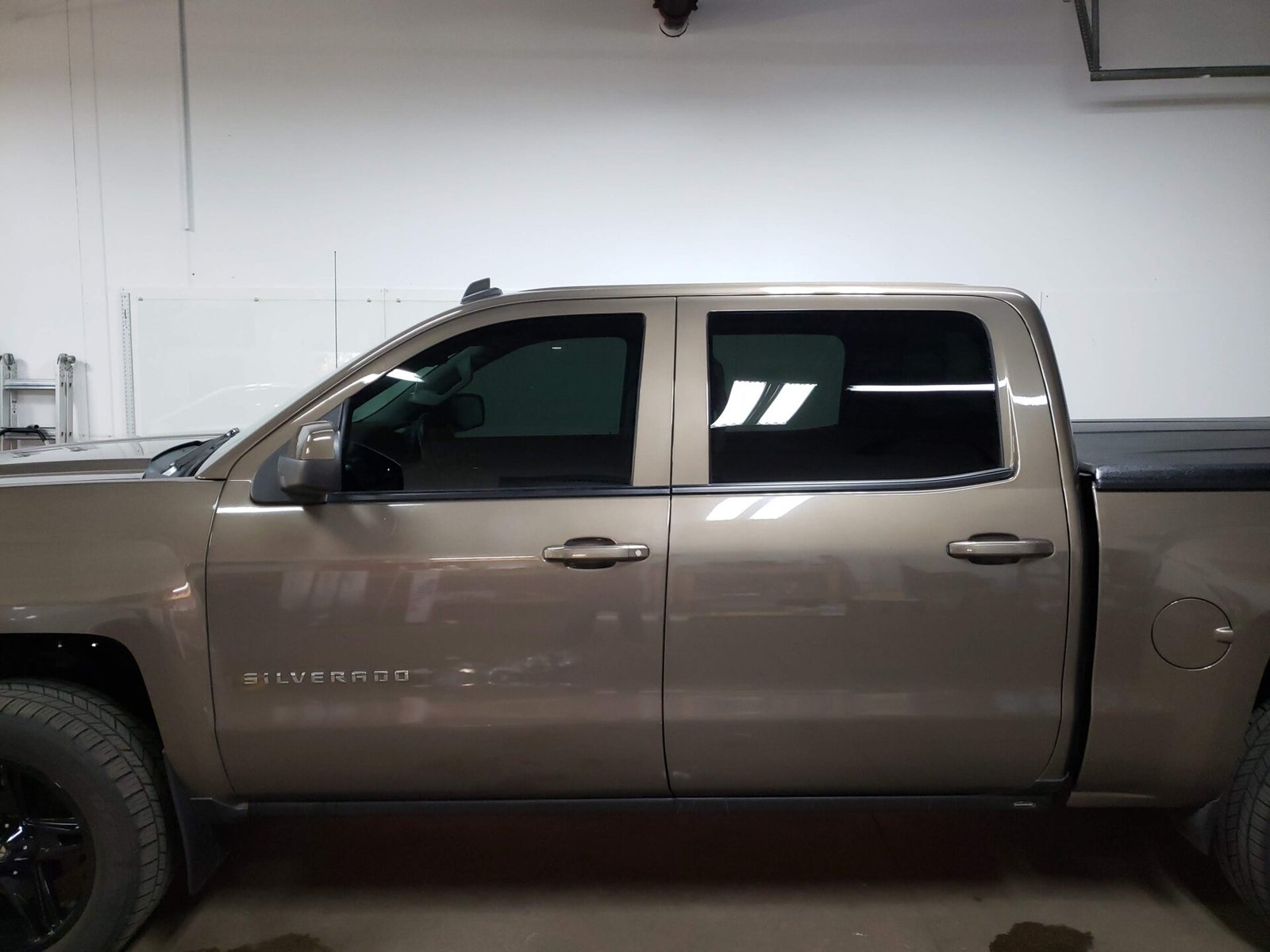 A side photo of a brown pick up car