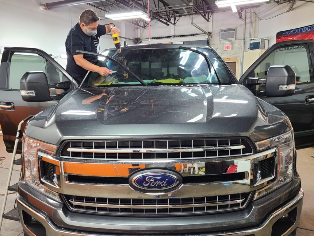 A person on a hood of the car